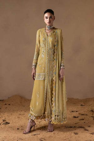 Woman wearing a yellow embroidered outfit with a matching dupatta against a beige background