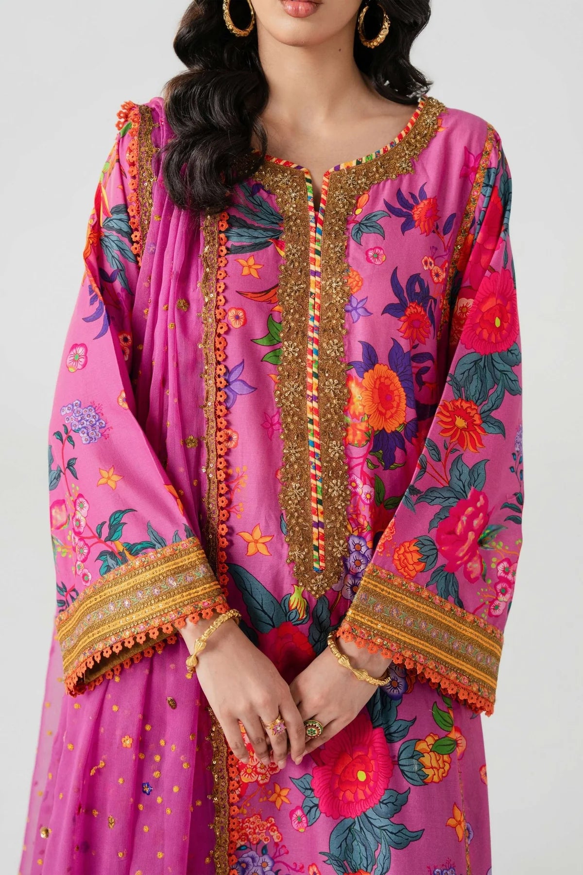 Woman wearing a vibrant pink traditional outfit with floral patterns and gold embroidery on a white background.
Ihasa Bai By Ruuposh Collection 06