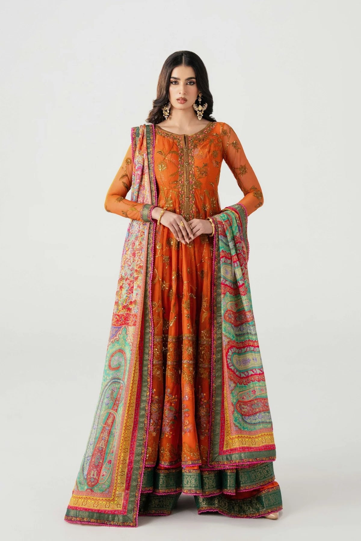 Woman wearing an orange traditional outfit with a colorful dupatta on a white background.
Mahlaqa Bai By Ruuposh Collection 04