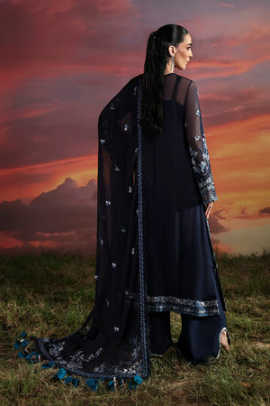 Woman in a dark blue traditional outfit with floral patterns against a sunset sky.
Muse_By_Ruuposh_Collection_04