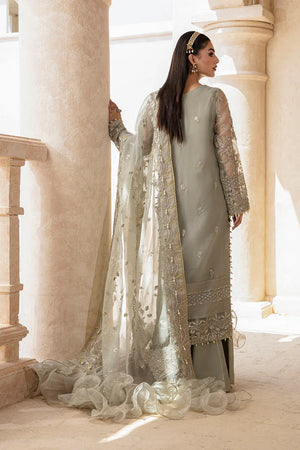Woman in a light blue traditional outfit with a white dupatta standing in a sunlit room.
Mushk_By_Ruuposh_Collection_5