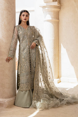 Woman in a silver embroidered traditional outfit standing in a bright, elegant interior setting.
Mushk_By_Ruuposh_Collection_6