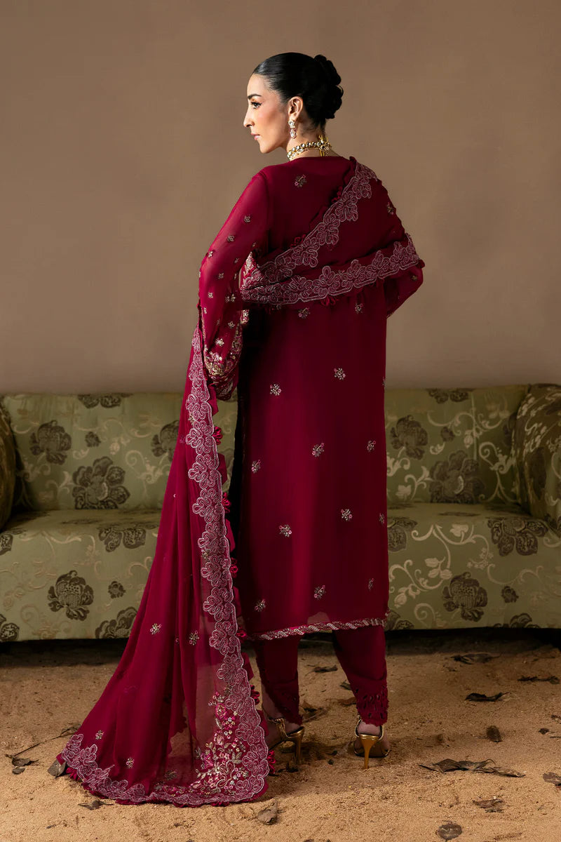 Woman in a red traditional outfit standing in front of a patterned sofa.
Poise_By_Ruuposh_Collection_5