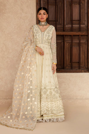 Woman wearing a cream embroidered traditional outfit with a wooden panel background.
Raniya_By_Ruuposh_Collection_41