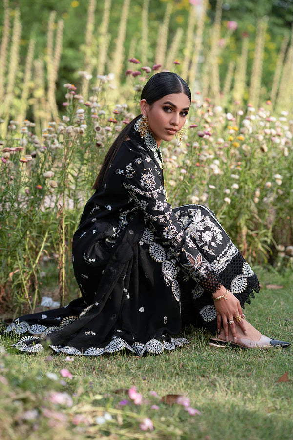 Woman in a black embroidered outfit sitting in a garden with flowers.
Selara_By_Ruuposh_Collection_3