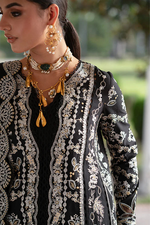 Woman wearing a black and white embroidered traditional outfit with gold jewelry.
Selara_By_Ruuposh_Collection_6