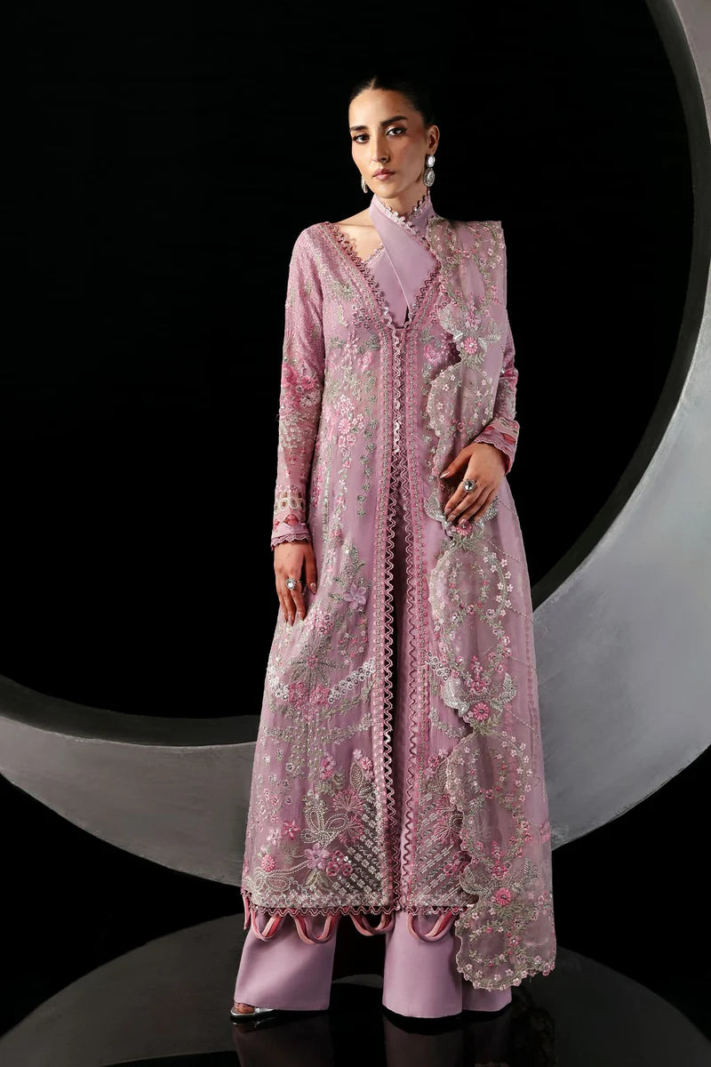 Woman wearing a pink embroidered traditional outfit against a black and gray background.
Serein By Ruuposh Collection 01
