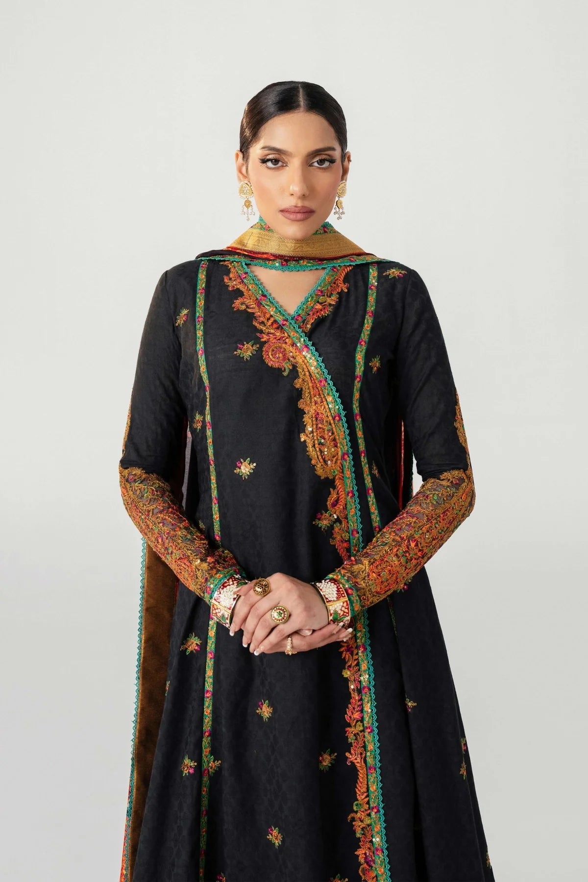 Woman wearing a black traditional outfit with colorful embroidery on a white background.
dochalla_By_Ruuposh_Collection_01
