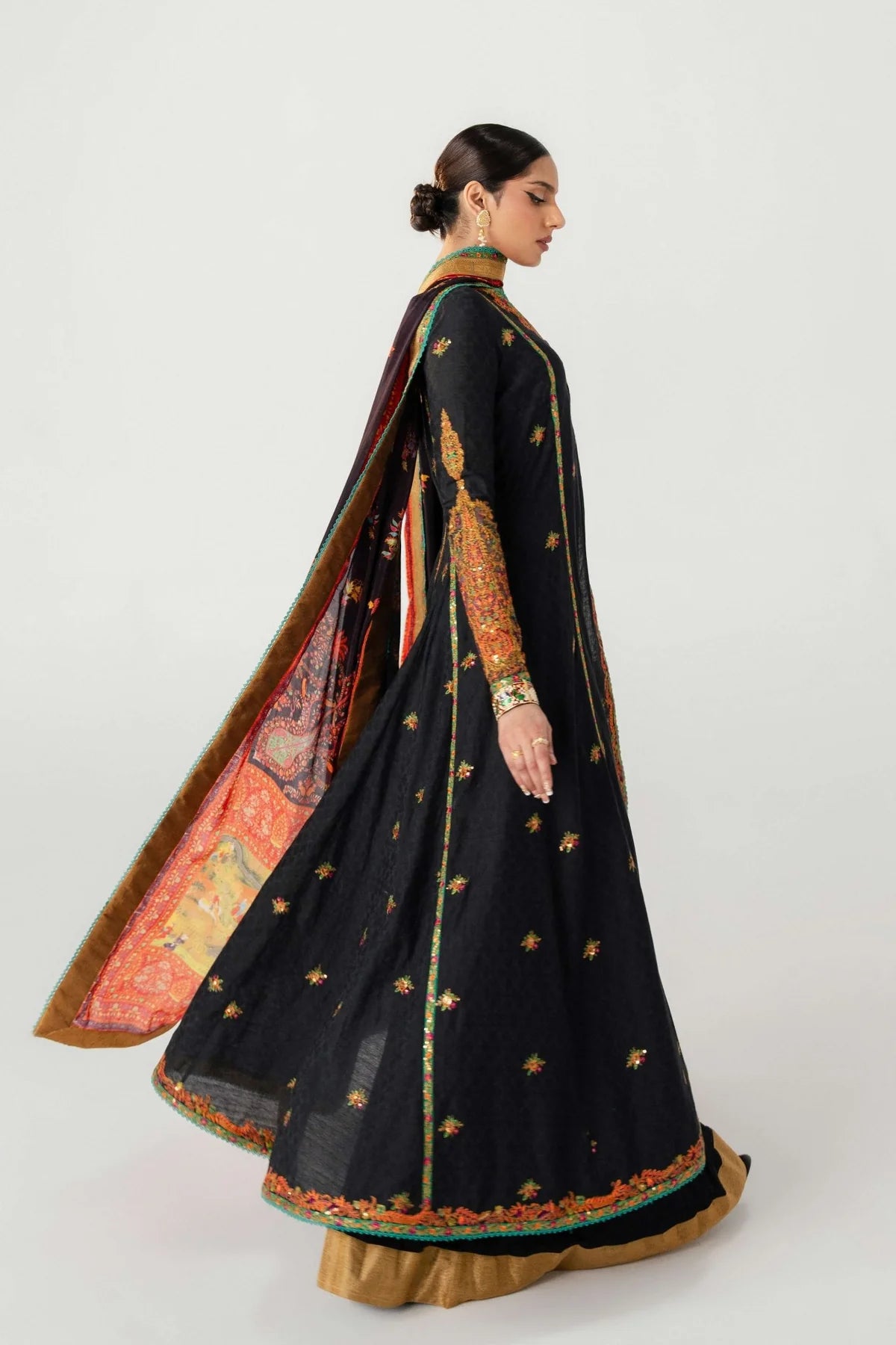 Woman wearing a black saree with gold embroidery on a white background
dochalla_By_Ruuposh_Collection_02