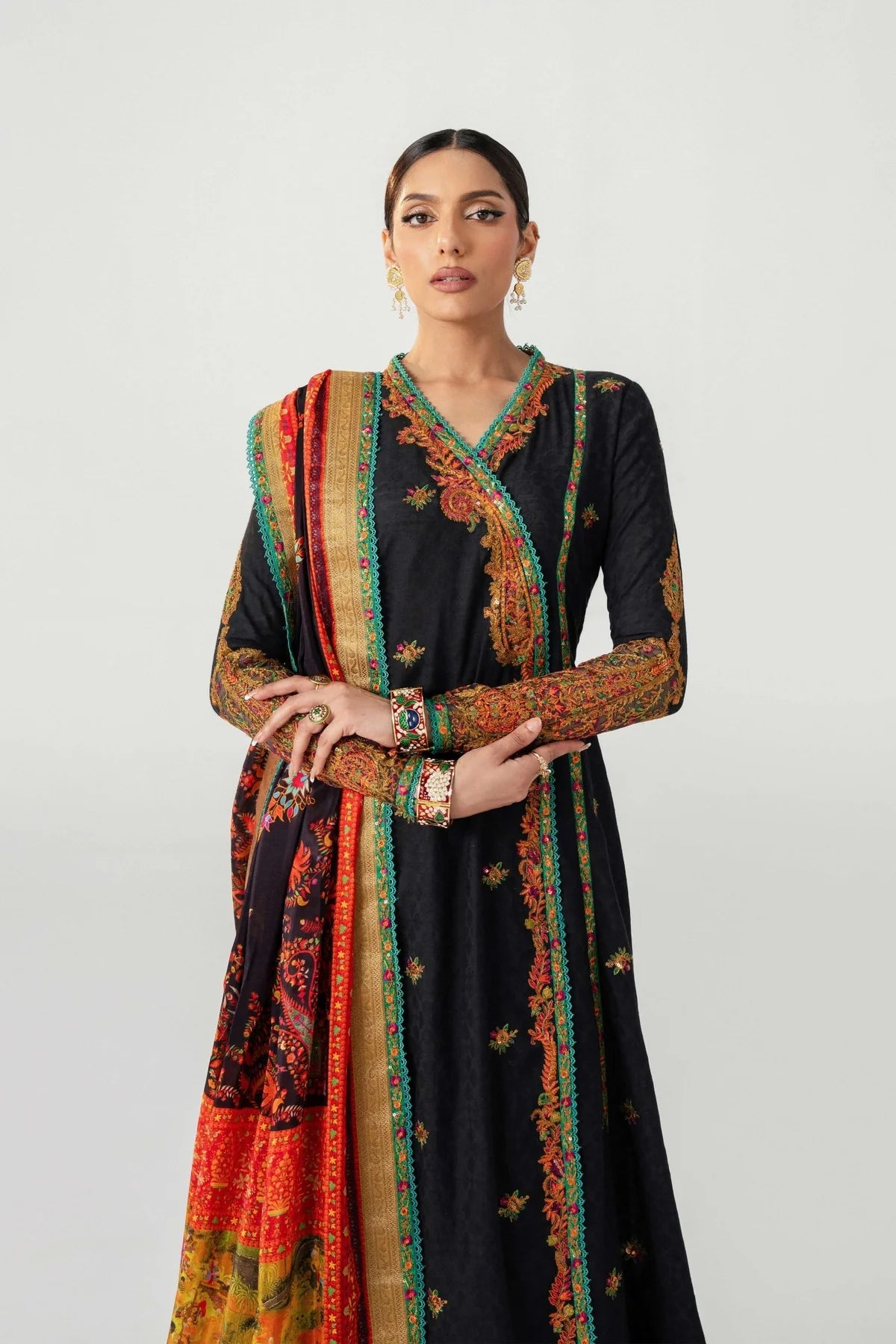 Woman wearing a black dress with colorful embroidery on a white background.
dochalla_By_Ruuposh_Collection_08